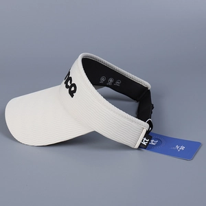 Detail view of cream sun visor showing UPF 50+ protection tag and knit texture