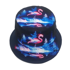 Reversible bucket hat with flamingo and blue forest print in a retro dreamlike style