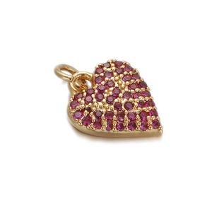 Macro shot of gold heart pendant with pavé set purple cubic zirconia and bail