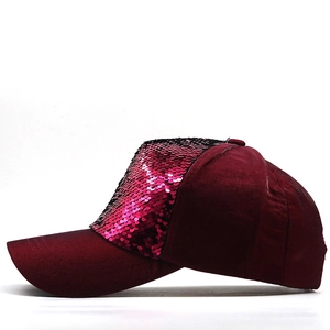 Close-up of sparkling burgundy sequins on the front panel of a casual baseball cap