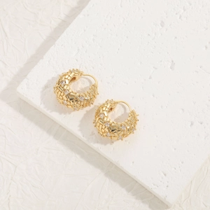Close-up of 14K gold-plated woven texture earrings set with cubic zirconia stones
