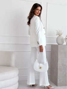 Full body view of a white double-breasted suit set with matching trousers and a handbag
