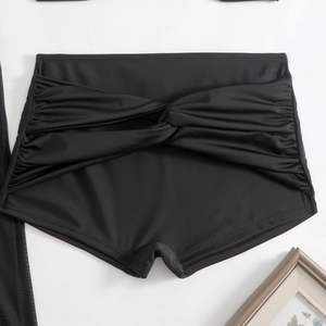 High-waisted black swim shorts with front twist knot and ruched tummy control design