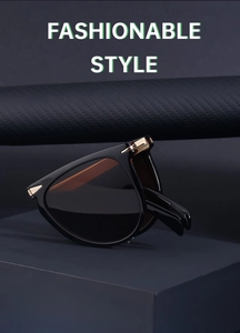 Detail of golden triangular hinges on black folding sunglasses with a fashionable style