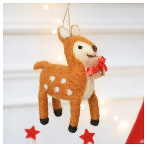 Close-up of a handmade wool felt reindeer ornament with a red gift box for Christmas