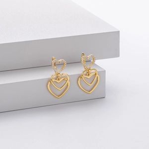 Elegant gold stacked heart drop earrings with white zircon accents on white background