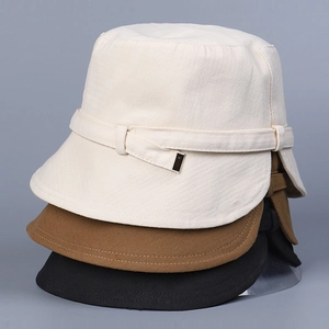 Stacked view showing off-white, brown and black fabric bucket hats with metal buckles