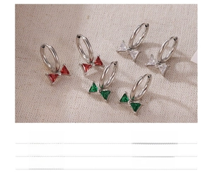 Detail of titanium steel bow earrings with red green and white zircon inlays