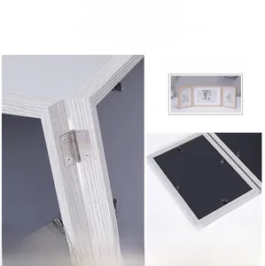Detail of Nordic triple folding photo frame with light gray wood grain and metal hinges