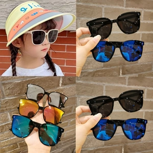 Detail view of colorful UV protection kids sunglasses and a yellow sun hat for summer