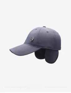 Detailed side view of winter baseball cap with integrated ear flaps and metal logo