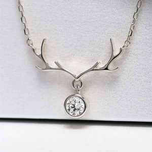 Close-up of S925 silver reindeer antler pendant necklace with sparkling round zircon