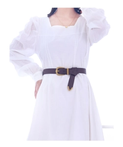 Brown leather waist belt with gold pin buckle styled on a white dress detail