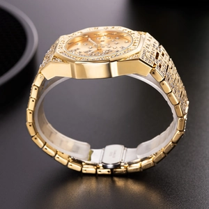 Detail of gold crystal-encrusted watch buckle with stainless steel engraving