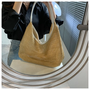 Mirror selfie showing a beige straw woven tote bag with white leather straps