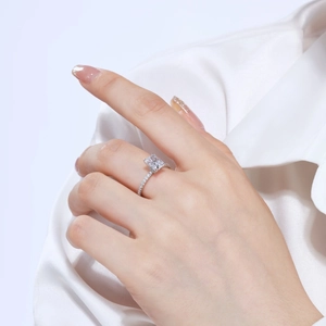 Macro detail of a radiant cut square zircon ring with pave diamonds on a silver band