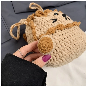 Close-up of handmade crochet lion bag with detailed beige knit and brown mane texture