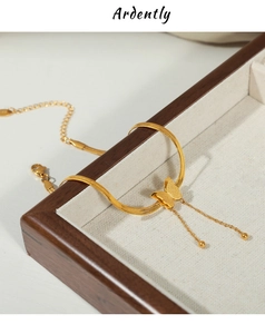 Close-up of gold butterfly anklet with 925 silver hallmark in a luxury wooden box