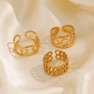 Three-piece set of gold-plated stainless steel chain rings on beige silk fabric