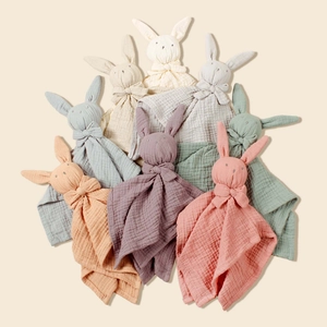 Detail showing eight organic muslin cotton rabbit comforters in diverse soft Morandi colors