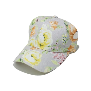 Detailed view of yellow floral print on light grey cotton baseball cap fabric texture