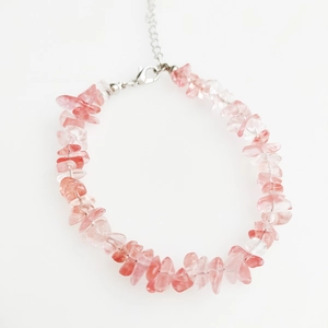 Detail of pink crystal chips bracelet with silver lobster clasp on white background