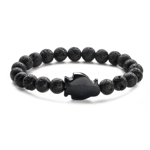 Close-up of black lava stone beads and sparkling blue sandstone fish charm bracelet