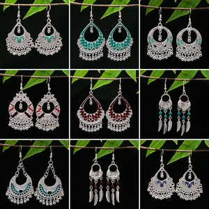 Bohemian silver alloy drop earrings set with colorful beads on natural branch display