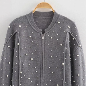 Grey knitted bomber jacket with faux pearl embellishments and silver zipper closure