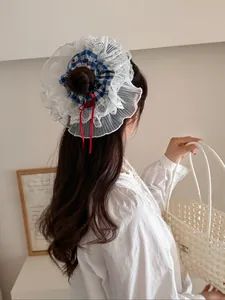 Detail of blue plaid headband with lace trim and red bow on model's hair