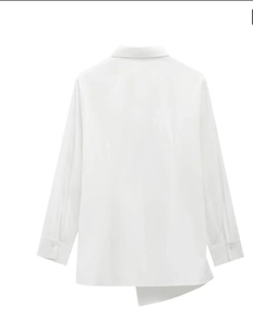 Back view of a white cotton shirt showing the unique asymmetric irregular hemline detail