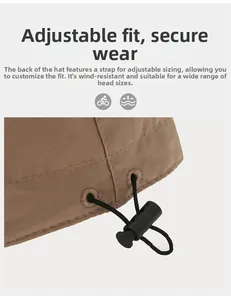 Detail of adjustable windproof elastic drawstring with plastic toggle on khaki sun hat