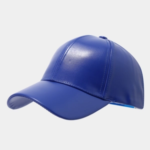 Close-up of royal blue faux leather baseball cap showing refined stitching and texture