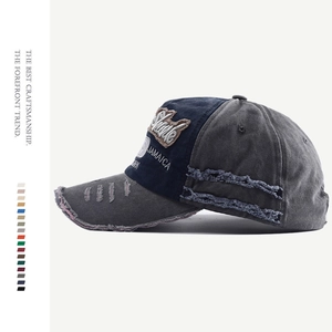 Detail view of distressed washed denim baseball cap with JAMAICA embroidery and stitching