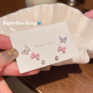 Detailed set of S925 silver stud earrings featuring pink bows and sparkling zirconia