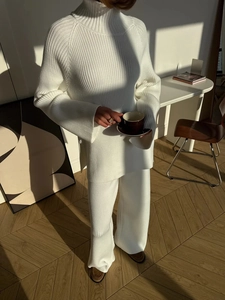 White ribbed knit two-piece set featuring turtleneck sweater and wide-leg pants