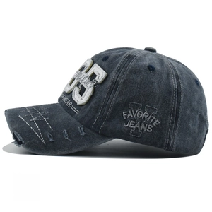 Detailed macro view of vintage washed cotton baseball cap with 95 patch and distressed brims