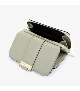 Detail view of open light green leather wallet showing interior zipper and card slots