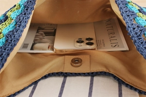 Detail view of large woven bag interior showing magnetic clasp and spacious storage