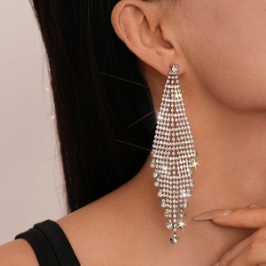Close-up of sparkling silver tassel earrings with crystal fringe in a triangle design