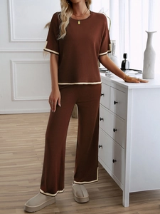 Detail of soft knit brown lounge set with cream trim on cuffs and wide-leg pants