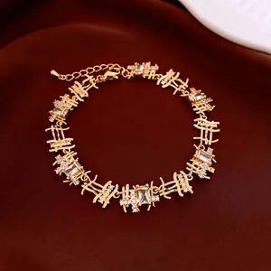 Golden bracelet with zircon rectangles on red velvet, adjustable luxury jewelry set