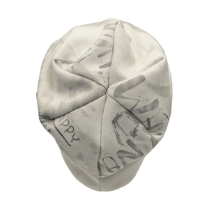 Close-up of the grey knitted beanie featuring artistic black graffiti letter patterns