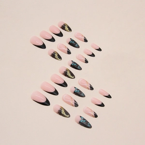 Almond-shaped press-on nails with black French tips, blue butterflies, and gold glitter