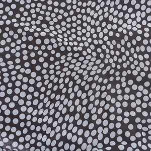 Close-up of square neck polka dot dress fabric showing high-quality black textile fiber