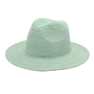 Close-up of mint green straw fedora hat featuring a fine spiral weave texture for summer