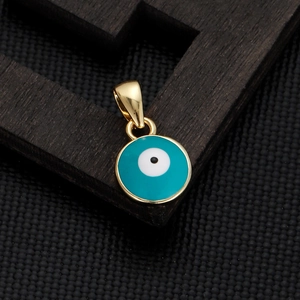 Macro shot of gold-plated lucky evil eye pendant with blue enamel and intricate metalwork