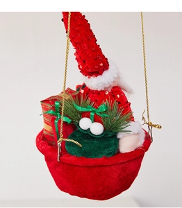 Close-up of Santa Claus in a festive hot air balloon basket with sequins and pine needles