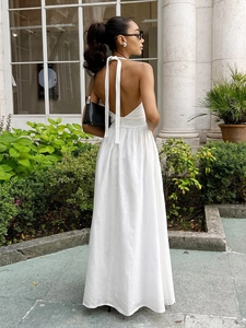 White halter backless cotton maxi dress with high waist and flowing A-line silhouette