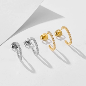 Macro detail of S925 silver C-shape earrings with colorful cubic zirconia stones